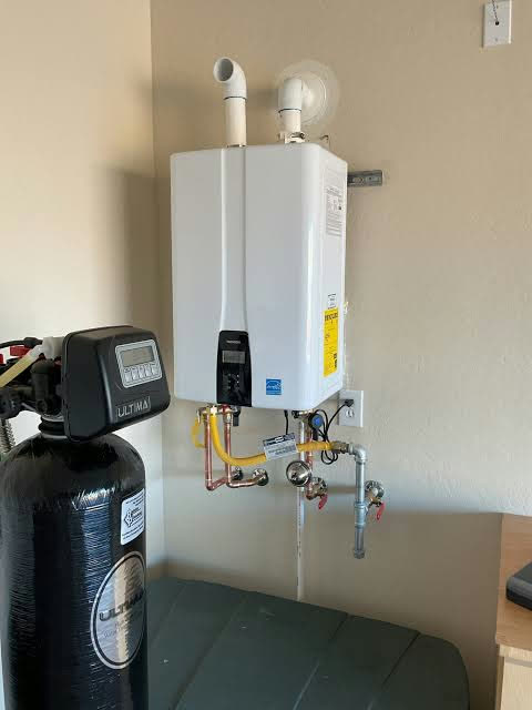 A wall-mounted tankless water heater with its gas and water lines